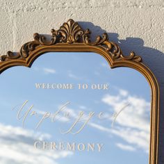 an ornate gold framed mirror with the words welcome to our marriage ceremony written in cursive writing