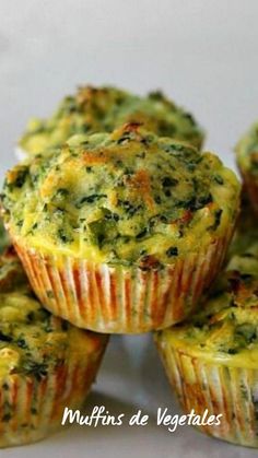 several small muffins are stacked on top of each other with cheese and spinach