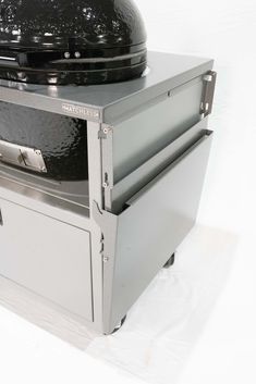 a large black grill sitting on top of a white table