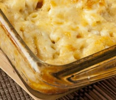 a casserole dish with cheese and meat in it sitting on a table top