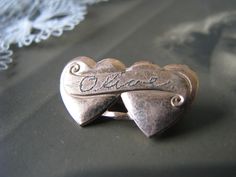 "A vintage rose gold plate double heart Sweetheart name brooch/pin. It measures 1'' x over 1/2''. Etched \"Olivia\" on the front. In beautiful condition with minor signs of wear." Heart-shaped Brooch For Valentine's Day Anniversary, Heart-shaped Brooch For Anniversary On Valentine's Day, Heart-shaped Brooches For Valentine's Day Anniversary, Vintage Wedding Brooches For Valentine's Day, Rose Gold Plate, Vintage Names, Vintage Rose Gold, Love Token, Heart Brooch