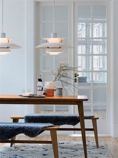 a dining room table with two chairs and a bench