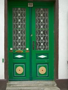 a green door with two glass panes on it