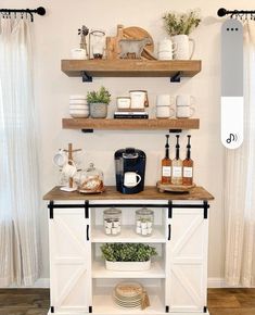 a kitchen with open shelving and shelves filled with dishes, coffee mugs and other items