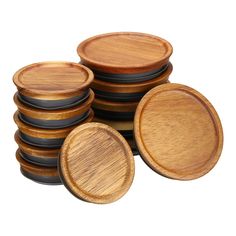 a stack of wooden plates sitting on top of each other in front of a white background