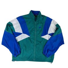 1980s Vintage Nike Track Jacket Windbreaker. Retro Vintage Windbreaker in Forrest Green, Blue & White. Pull String Clamps and Overlay with Mesh Underlay.  *  No Internal Tags, Medium Oversized to XXL Standard Fit (See Measurements) *  Subtle Blemish as Shown with Hands Approximate Measurements; Not Exact   *  Pit to Pit Approx. 27" *  Shoulder to Hem Approx.  29.5" 📦  Bundle Discounts on Multiple Items 📫  Fast Shipping 🌱 Sustainable Business ⭐️ 5 Star Seller   Streetwear Sportswear Logomania Streetwear Sportswear, Nike Track Jacket, Nike Vintage, Green Retro, Vintage Windbreaker, Sustainable Business, Nike Blue, 1980s Vintage, Track Jacket