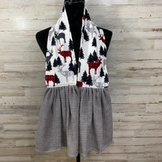 a women's vest with deer and pine trees on it