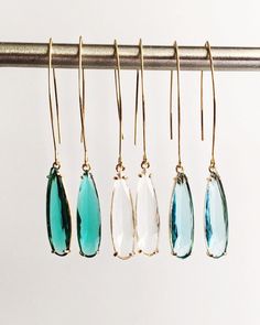 Clear, Emerald Green, and Aquamarine Teardrop and Gold Long Dangle Earrings ⟡ all items are designed and handcrafted in our studio ⟡ Long teardrop glass and gold long teardrop earrings. The glass stone is set into a gold plated over brass setting. These beautiful stones - clear diamond, emerald green, and aquamarine blue - are such beautiful stones and would be perfect to wear all year long. The long earring wire adds a dramatic but simple look that can easily be dressed up or dressed down.  This listing is for one pair of earrings.  OVERVIEW -3" in length -glass crystals -gold plated over brass (nickel free) MORE EARRINGS https://www.etsy.com/shop/Lynnique?ref=condensed_trust_header_title_reviews§ion_id=5813899 CONTINUE SHOPPING https://www.etsy.com/shop/lynnique REVIEWS "Another gorgeous Teardrop Threader Single Earring As Gift, Modern Dangle Crystal Earrings As Gift, Teardrop Jewelry With Ear Wire For Parties, Party Drop Linear Earrings With Ear Wire, Modern Crystal Drop Earrings Gift, Modern Crystal Drop Earrings For Gifts, Modern Drop Crystal Earrings For Gift, Party Teardrop Long Drop Earrings, Party Drop Jewelry With Ear Wire