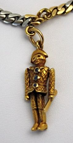 This special charm necklace alternates between links of platinum and links of 18k yellow gold and has an extremely secure lock. Suspended from this unusual chain are five exceptionally unique and very rare enameled charms, all in 18k gold. The detailed clown charm holds a baton and his shirt has three sapphires as buttons. There is also an Uncle Sam charm (enamel could use restoration), a devil with a tail holding a pearl, an American Indian with a tomahawk and feathered headdress, and a lady sw Gold Enamel Necklace With Chain, Antique Yellow Gold Enamel Necklace, Luxury Yellow Gold Necklace With Vintage Charm, Engraved Yellow Gold Necklace With Enamel, Antique Enamel Necklace With Hallmark, Antique Enamel Necklace Hallmarked, Antique Enamel Hallmarked Necklaces, Gold Enamel Jewelry With Vintage Charm, Antique Enamel Charms Jewelry