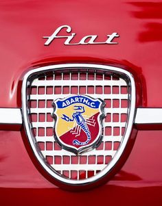 an emblem on the front of a red car