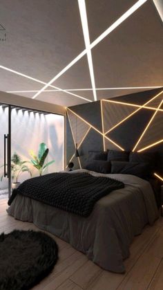 a modern bedroom with black and white lighting on the ceiling, bed in foreground