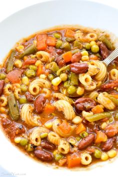 a white bowl filled with pasta and vegetables