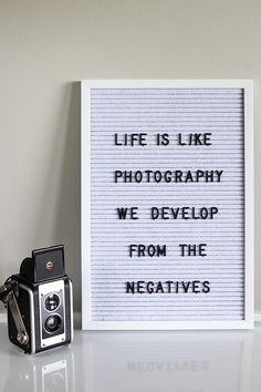 a sign that says life is like photography we develop from the negatives