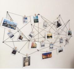 a white wall with many pictures hanging on it's sides and clothes pins attached to them