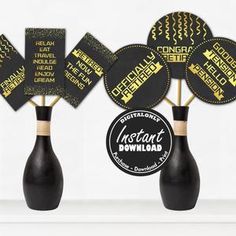 black and gold party decorations on sticks in vases