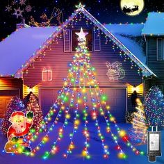 a christmas tree is lit up in front of a house with santa clause on it