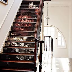 a stair case with flowers painted on it