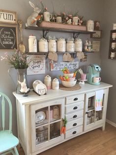 an image of a room that is decorated in white and has many items on the shelves