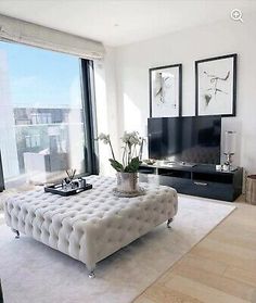 a living room filled with furniture and a flat screen tv