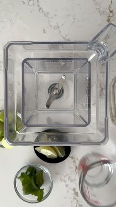 an overhead view of a blender on a marble counter top with ingredients around it