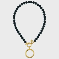 This round statement piece pops with toggle detail on a black onyx strand. Genuine black onyx stone, 24Kt triple gold plating 16 inches, toggle closure. • Made in United States Susan Shaw, Black Onyx Necklace, Onyx Necklace, Black Onyx Stone, Meaningful Jewelry, 24kt Gold, Onyx Stone, San Antonio Tx, Necklace Designs