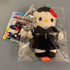 the hello kitty doll is wearing a police uniform