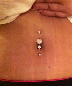 a woman's stomach with three diamonds on it