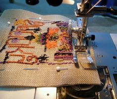 a close up of a sewing machine with a piece of fabric on the table next to it