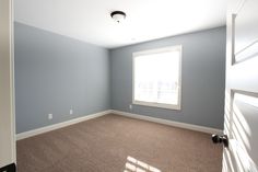 an empty room with blue walls and carpet