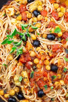 pasta with tomatoes, olives and herbs in a skillet ready to be eaten