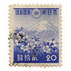 a stamp with flowers and mountains on it