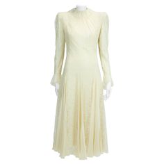 This early 80's Scherrer haute couture dress could be a fabulous option for a bride-to-be. Made from delicate off-white lace which is underpinned with a refined color matching silk-chiffon to reduce the transparency, this dress features fine godet pleats through the tiered skirt that fans out from the hips. Gently puffed sleeves (shoulder pads are sewn but easy to remove). The lace collar and cuffs are framed with fluttery ruffles for added sweetness and romantism (see pictures 8, 10 & 16). The dress fastens at the back with a concealed zip and a series of ten hand covered silk buttons. Mini press studs are sewn between the top buttons for the fabric to really hold in place (that's couture !). The ruffled collar closes with three hook-and-eye, while the cuffs with four hand covered silk bu Haute Couture Dress, Jean Louis Scherrer, Dark Red Lips, Haute Couture Dresses, Couture Dress, Ruffled Collar, Lace Collar, Puffed Sleeves, Tiered Skirt