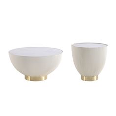 two white bowls with gold rims sitting on top of each other in front of a white background