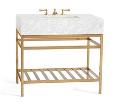 a bathroom vanity with marble top and gold metal frame, undermounted faucet