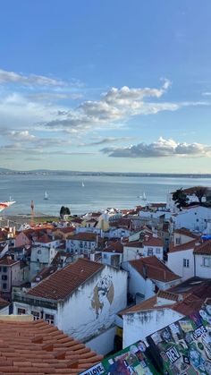 the city is full of colorfully painted buildings and boats on the water in the distance