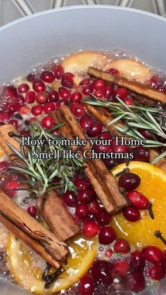 a pot filled with oranges, cinnamon sticks and cranberries