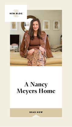 a woman sitting on top of a bed next to a brown and white zebra print