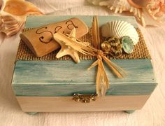 a small wooden box with shells and seashells