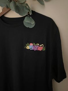 "Hi! This listing is for a 100% cotton tee with a hand-embroidered Floral design coming out of pocket! Make for perfect gifts!  Tees are high quality, soft, tagless and 100% cotton. All tees run true to size. Sizing charts are listed below. Adult Tee Sizing (in inches): *Tees hit at the hip. XS: Chest- 30-32\" // Hip- 33\" S: Chest- 34-36\" // Hip- 34-36\" M: Chest- 38-40\" // Hip- 37-39\" L: Chest- 42-44\" // Hip- 40-42\" XL: Chest- 46-48\" // Hip- 43-44\" XXL: Chest- 50-52\" // Hip- 45-46\" Kids Tee Sizing (in inches): S (6-7): Height- 48-49.5\" // Chest- 26\" M (8): Height- 50-52\" // Chest- 27\" L (10-12): Height- 56-58\" // Chest- 28\" XL (14-16): Height- 61-64\" // Chest- 31\" XXL (18): Height- 65-66\" // Chest- 32\" Care Instructions: Garment is safe to machine wash, but would recom Tshirt Embroidery, Flower Pocket, Stitched Flowers, Out Of Pocket, Floral Pocket, Flower Shirt, Pocket Shirt, Pocket Tee, Kid Tees