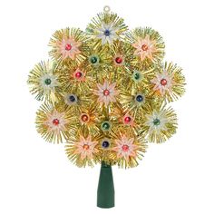 a green vase filled with lots of gold and red flowers on top of a white table