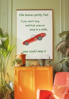 an orange chair in front of a poster with a quote on it