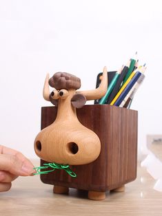 Add a touch of humor to your workspace with our Whimsical Wooden Cow Pen Holder. This quirky pen holder features a playful cow design, perfect for organizing your pens, pencils, and other writing tools. Crafted from high-quality wood, it combines functionality with a fun and lighthearted aesthetic. Ideal for home offices, classrooms, or as a unique gift, this pen holder is sure to bring a smile to your face while keeping your desk tidy and organized. Material:woodenSize:10cm(L)*13cm(W)*15.5cm(H) (1 inch=2.54cm) Wooden Cows Crafts, Office Desk Art, Functional Art Ideas, Wooden Products Ideas, Lighthearted Aesthetic, Wooden Decorative Items, Wooden Home Accessories, Pen Holder Design, Cow Pen