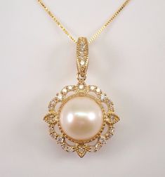 "Yellow Gold Diamond and Pearl Halo Pendant Sun Necklace with Chain. This pendant is set with one Round Cultured White Pearl and twenty-nine genuine Round Brilliant Diamonds. The diamonds in this pendant are H color, SI/I clarity and weigh a total of .22 carat. The pearl in this pendant measures 8 mm in diameter. This pendant comes accompanied with an 18\" 10KT Yellow Gold chain. The pendant and chain weigh a total of 3.1 grams and the pendant measures 23.5 X 15 mm.  This necklace will be accompanied by an appraisal written by a GIA Certified Diamond Grader with the retail replacement value of $1,385.00. I will ship this necklace promptly in a beautiful gift box. ADDITIONAL REQUESTS If you would like to see more pictures of this item, please let us know and we would be happy to provide the Elegant Round Pearl Necklace With Intricate Design, Elegant Pearl Necklace With Intricate Design, Elegant Gold Pearl Necklace With Intricate Design, Elegant Pearl Necklace With 17 Jewels For Celebration, Ornate Round Necklace With Pearl Pendant, Ornate Round Necklaces With Pearl Pendant, Elegant Round Necklace With Intricate Design, Elegant Round Pendant Necklace For Celebration, Elegant Round Pendant Jewelry For Celebration