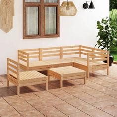 a wooden bench sitting on top of a tiled floor next to a potted plant