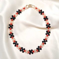 This elegant Coral, Pearl and Jade Necklace is the perfect accessory for any occasion. Delicately crafted with black jade, red coral, and freshwater pearls, this unique piece of jewelry is an eye-catching touch of sophistication to your look today! Black Jade (5mm) Red Coral (5mm) Freshwater Pearls (4mm) Goldfilled clasp Length: 15" Elegant Red Pearl Necklace With Gemstone Beads, Elegant Red Beaded Necklace With Black Beads, Elegant Red And Black Beaded Necklaces, Elegant Red And Black Beaded Necklace, Elegant Pearl Necklace With Colorful Beads For Gift, Black Jade, Jade Necklace, Jade Jewelry, Red Coral