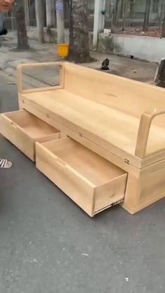 a man riding a skateboard past a wooden bench