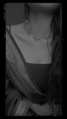 black and white photograph of a woman wearing a necklace