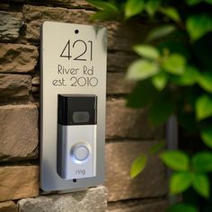 a ring video camera mounted to the side of a brick wall