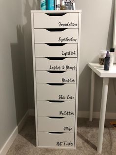 a tall white cabinet with lots of drawers