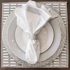 the place setting is ready to be served with silverware and napkins on it